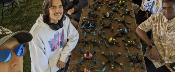 RotorJackets pose in front of their drones at the Collegiate Drone Racing Championship