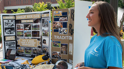 student talking to other students