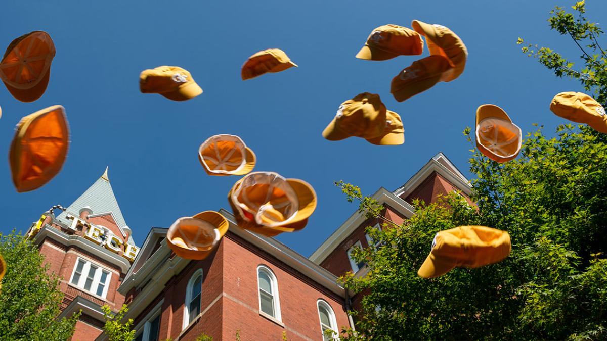 rat caps being thrown into air