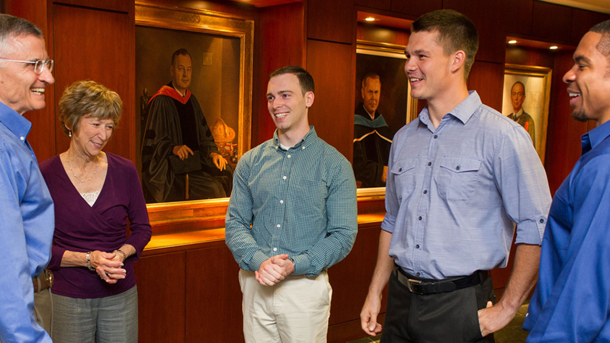alumni talking with current students