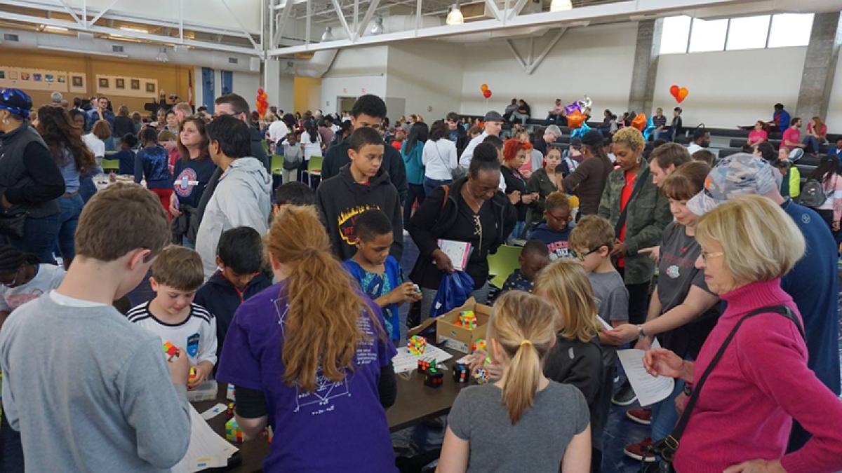 Attendees browse the demonstrations at a past Mathapalooza! event.