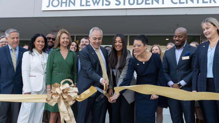 Luoluo Hong, vice president for Student Life and Well-Being, and Kanak Agarwal, president of Student Center Programs and member of the Student Center Expansion Committee, join President Ángel Cabrera to cut the ribbon at the dedication of the John Lewis Student Center.