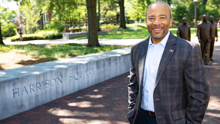 Raheem Beyah standing near Trailblazers sculpture.