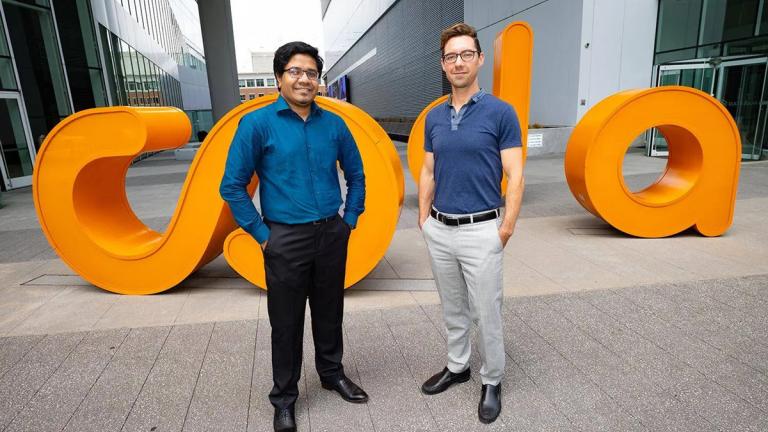 Brendan Saltaformaggio and Amit Sikder standing in front of Coda sign. 