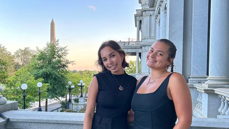 Students in the GTDC: Pathways to Policy program pose for a photo with the Washington Monument in the background.