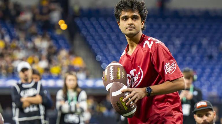 Sid Suratia is laser-focused and holding two footballs.