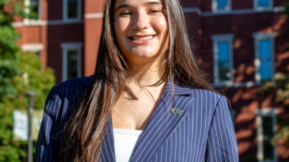 Headshot of Giuli Capparelli Sanabria in front of Tech Tower