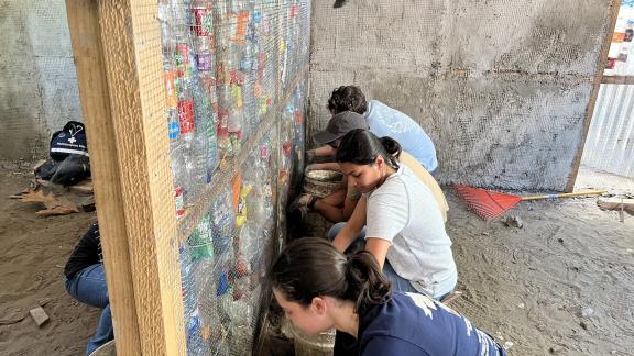 Last spring, one of Georgia Tech's Alternative Service Breaks was in the Dominican Republic. Students helped build bottle houses that have a cement foundation and a wooden frame, and the insulation is made of recycled plastic bottles to both reuse waste and protect homeowners during extreme temperatures. Photo courtesy of the Center for Student Engagement.
