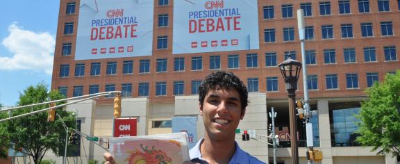 Alec Grosswald holds up a copy of the 'Technique' outside the Warner Media campus prior to the 2024 presidential debate. 