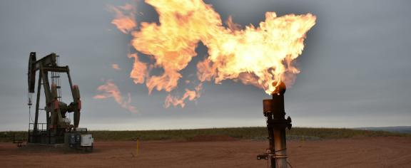 A flare burns natural gas at an oil well on Aug. 26, 2021, in Watford City, N.D. 