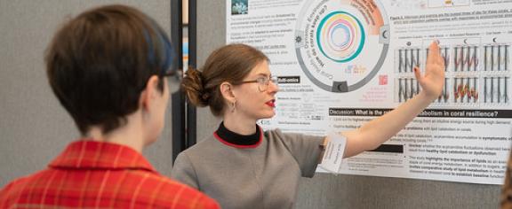 Gretchen Johnson explains her research to a judge during the competition.