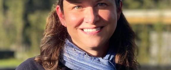 Headshot of a woman wearing a Dian Fossey gorilla fund ball cap