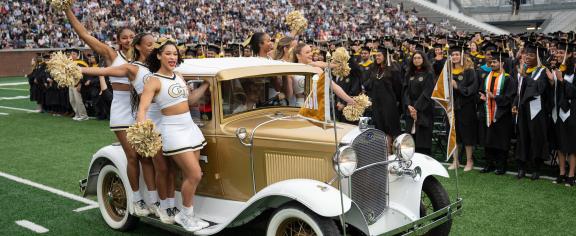 Cheerleaders on the Ramblin Wreck at Georgia Tech commencement ceremony at Bobby Dodd stadium. 