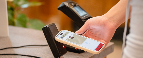 student uses mobile wallet to access dining hall