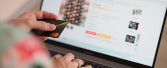Stock photo of person shopping online with a credit card