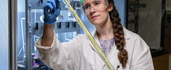 Georgia Tech grad student holding a hollow fiber membrane that can be used for low-energy chemical separation.