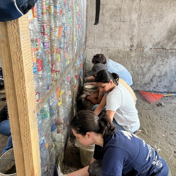 Last spring, one of Georgia Tech's Alternative Service Breaks was in the Dominican Republic. Students helped build bottle houses that have a cement foundation and a wooden frame, and the insulation is made of recycled plastic bottles to both reuse waste and protect homeowners during extreme temperatures. Photo courtesy of the Center for Student Engagement.
