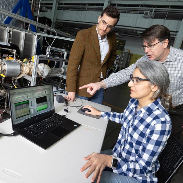 Postdoctoral fellow Poorandokht Kashkouli, seated, discusses test data from their direct air capture rig with Ryan Lively, left, and Chris Jones. The system pulls air across filter materials to remove carbon dioxide. (Photo: Candler Hobbs)